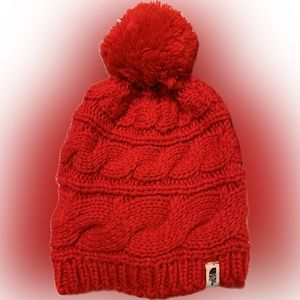 The North Face women’s beanie with pom. Bright red.